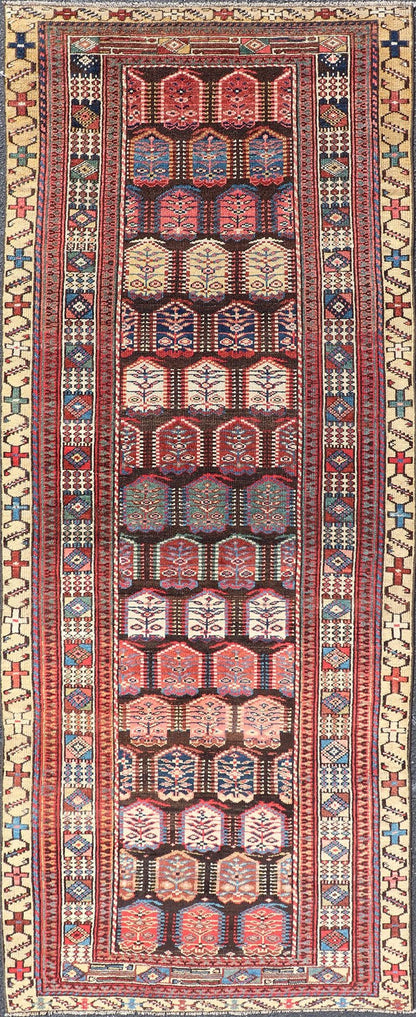 Measures: 3'3 x 8'4 This stunning antique Persian Kurdish runner showcases a vibrant and intricate design, reflecting the rich tribal heritage of Kurdish craftsmanship. The rug features a series of repeated medallions, each intricately detailed wit... - Keivan Woven ArtsEMB - 22288 - 26124Rug