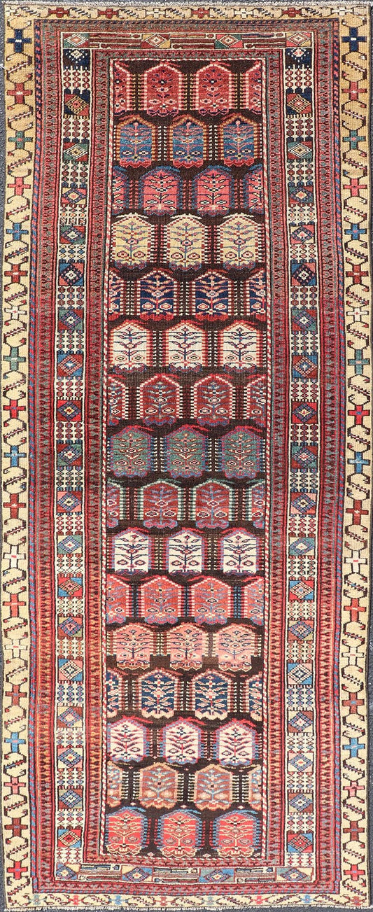 Measures: 3'3 x 8'4 This stunning antique Persian Kurdish runner showcases a vibrant and intricate design, reflecting the rich tribal heritage of Kurdish craftsmanship. The rug features a series of repeated medallions, each intricately detailed wit... - Keivan Woven ArtsEMB - 22288 - 26124Rug