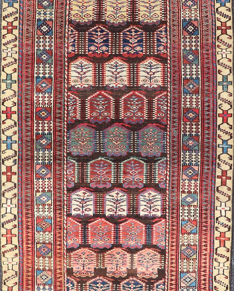 Measures: 3'3 x 8'4 This stunning antique Persian Kurdish runner showcases a vibrant and intricate design, reflecting the rich tribal heritage of Kurdish craftsmanship. The rug features a series of repeated medallions, each intricately detailed wit... - Keivan Woven ArtsEMB - 22288 - 26124Rug