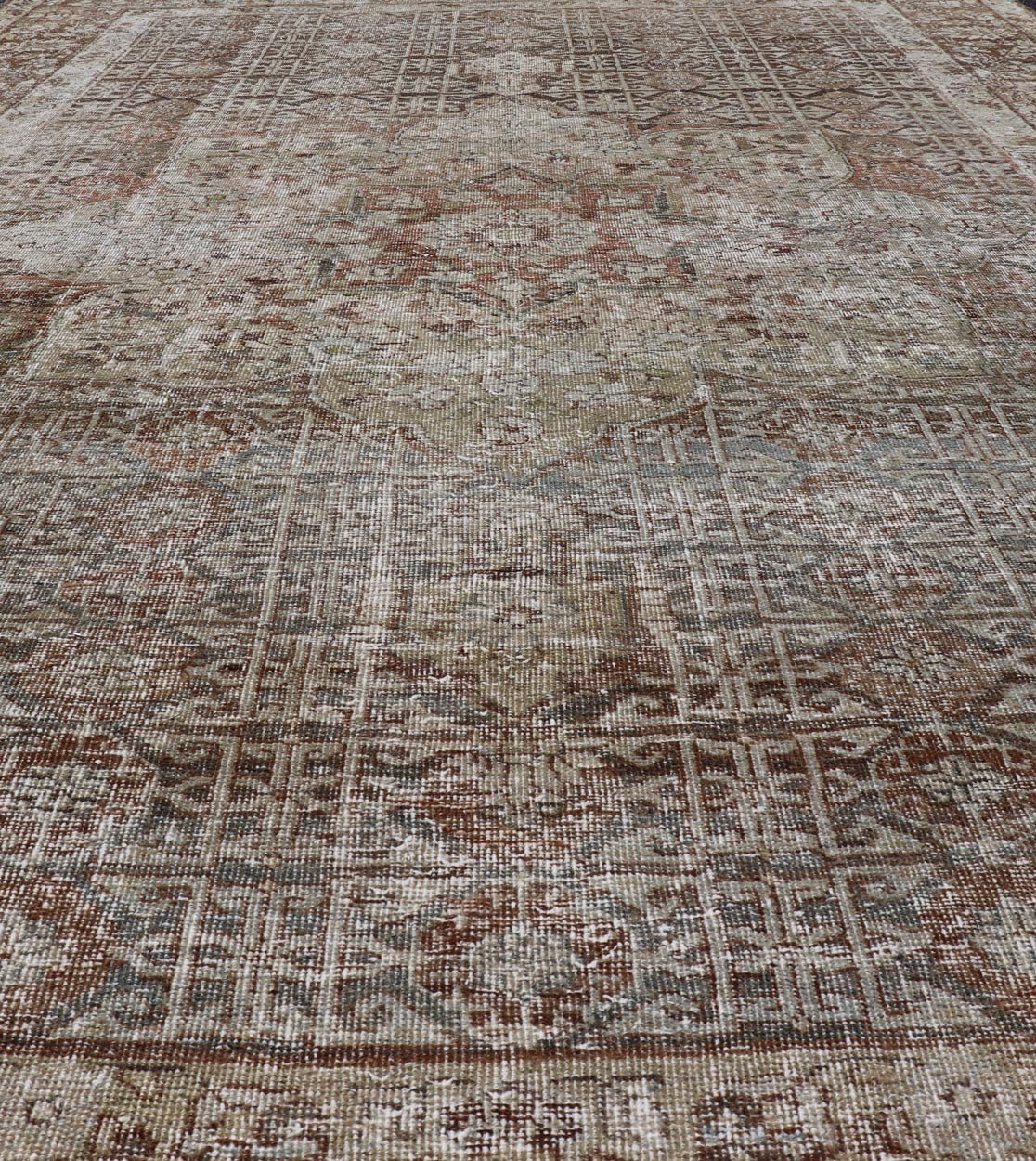 Antique Hand - Knotted Distressed Persian Mahal Rug in Wool with Medallion Design This antique distressed Persian Mahal rug has been hand - knotted in wool and features a large medallion design rendered in muted tones, a complementary, multi - tiered... - Keivan Woven ArtsEMB - 5000 - P13060 - 16406Rug