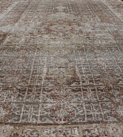 Antique Hand - Knotted Distressed Persian Mahal Rug in Wool with Medallion Design This antique distressed Persian Mahal rug has been hand - knotted in wool and features a large medallion design rendered in muted tones, a complementary, multi - tiered... - Keivan Woven ArtsEMB - 5000 - P13060 - 16406Rug
