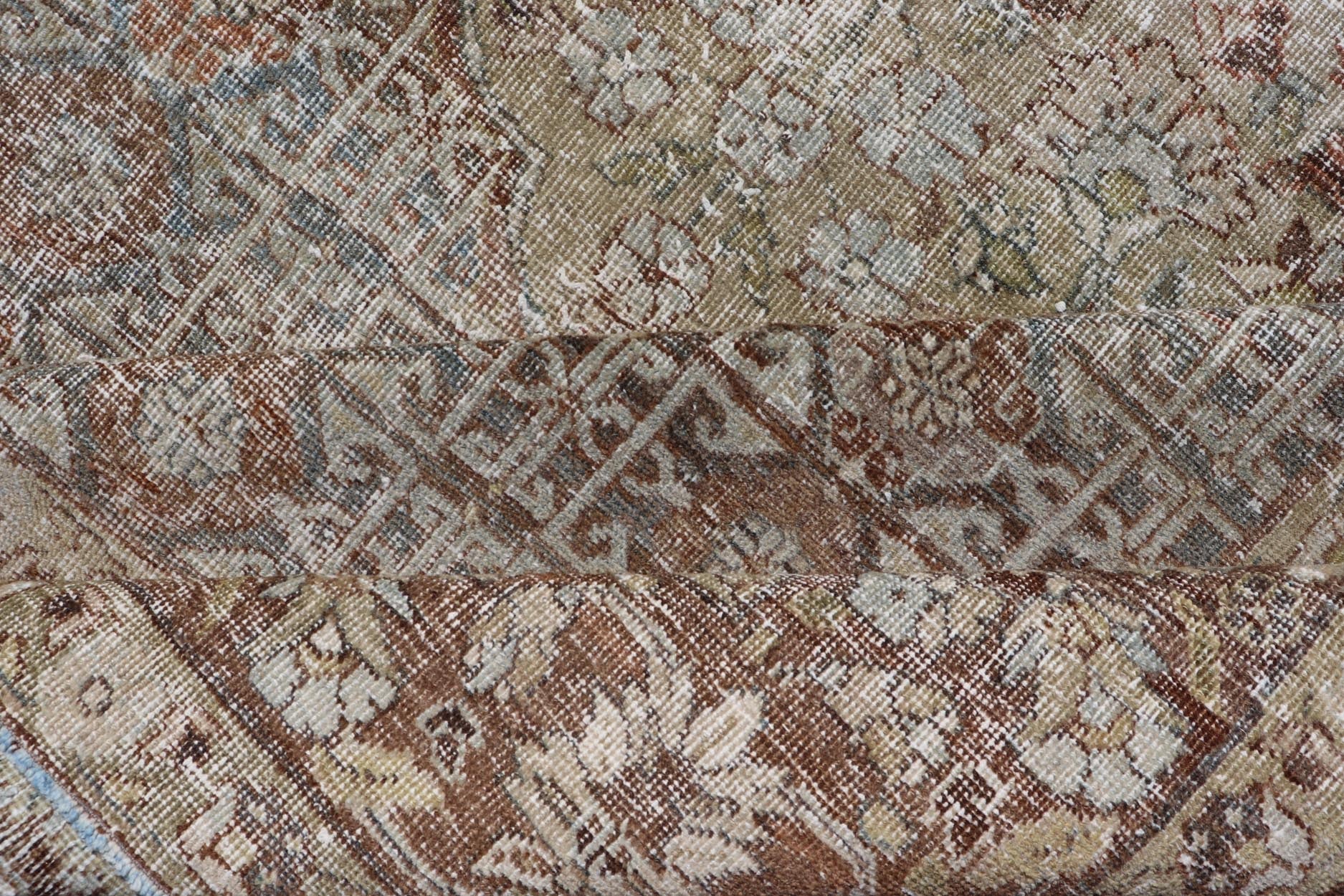 Antique Hand - Knotted Distressed Persian Mahal Rug in Wool with Medallion Design This antique distressed Persian Mahal rug has been hand - knotted in wool and features a large medallion design rendered in muted tones, a complementary, multi - tiered... - Keivan Woven ArtsEMB - 5000 - P13060 - 16406Rug