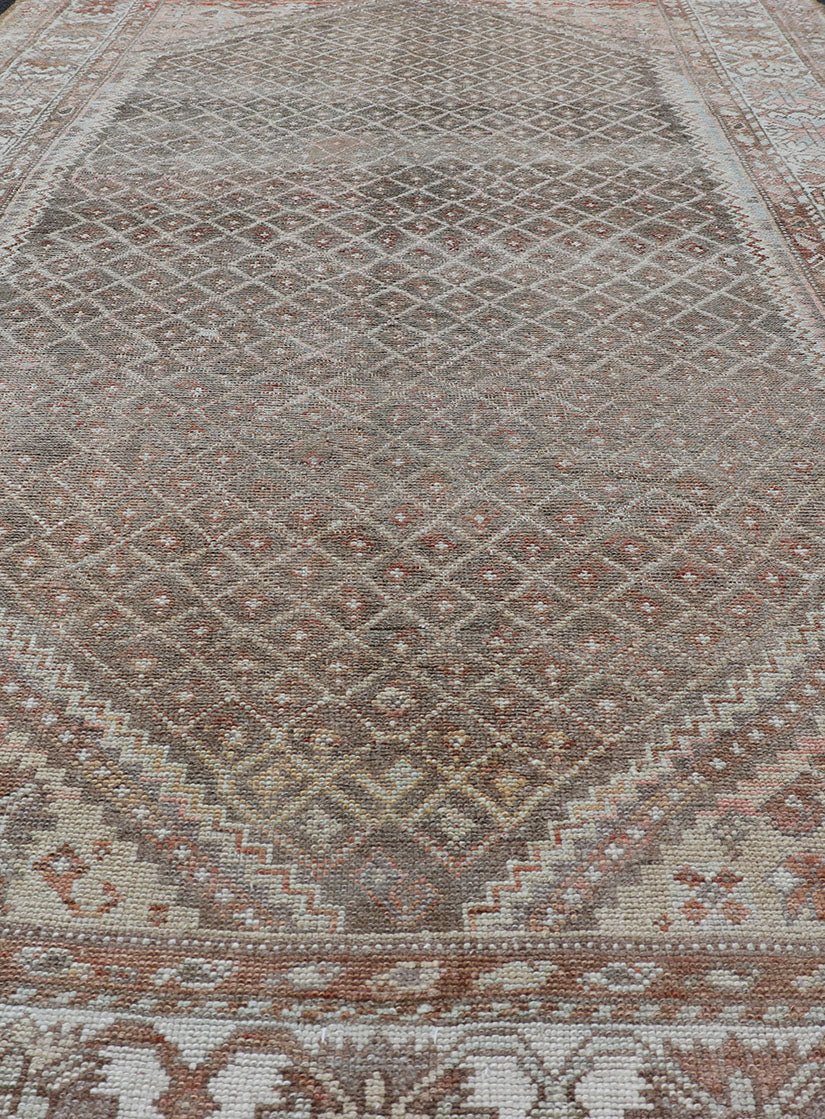distressed Antique Persian Kurdish Rug in Gray/Brown Background with Taupe Tan & Soft Red. Softly colored antique distressed Persian Kurdish with all - over tribal design in soft colors of gray, charcoal, brown, tan cream, green , rug EMB - 8529 - 17... - Keivan Woven ArtsEMB - 8529 - 178682 - 13696Rug