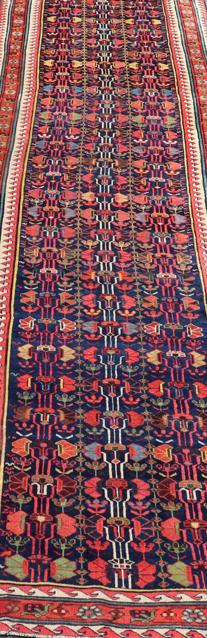 This antique runner was woven in the mountainous region of Caucasus, given much time for details in the field of a perfectly symmetrical all - over design. The field many colors of green, yellow, light blue, ivory and brown. The midnight blue background ... - Keivan Woven ArtsEMB - 8537 - 13778Rug