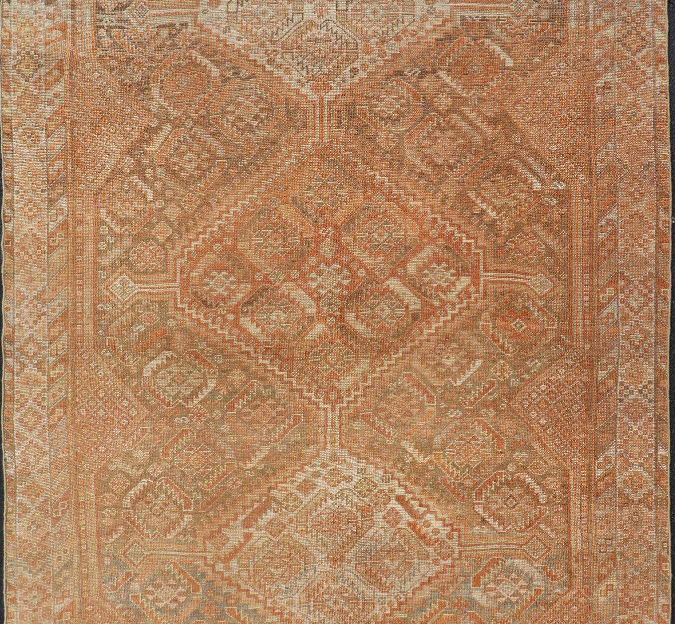 Antique Distressed Persian Shiraz Rug in Shades of Soft Orange, Lt. Brown, Gray. Persian antique Shiraz carpet in soft orange, light gray, light rust red and light brown with geometric medallions, rug EMB - 8545 - 06, country of origin / type: Iran... - Keivan Woven ArtsEMB - 8545 - 06 - 13806Rug