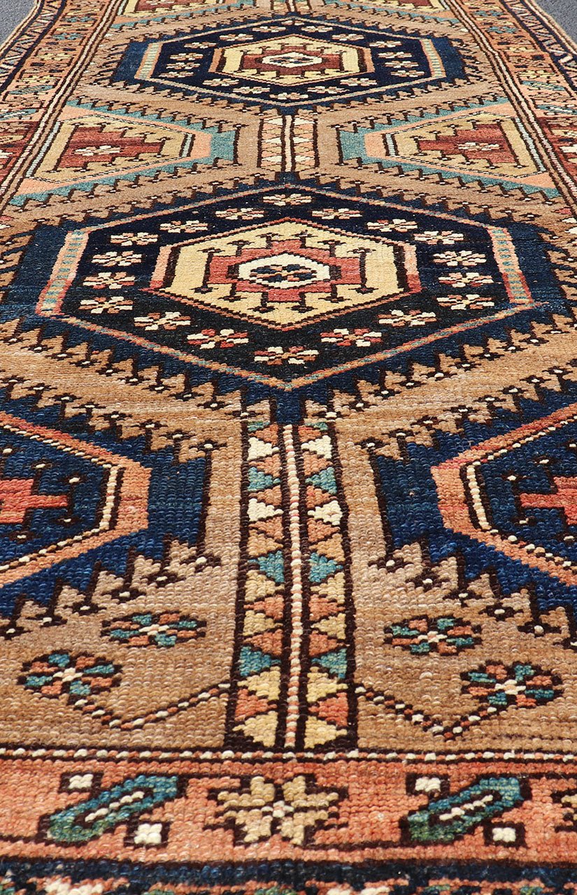 Antique Persian Kurdish Short Runner on Geometric Motifs in Light Camel Field. Medallion design on camel field, with dark blue medallions, green, red, blue , rug EMB - 8546 - 178695, country of origin / type: Iran / Hamedan, circa 1910 This ... - Keivan Woven ArtsEMB - 8546 - 178695 - 13812Rug
