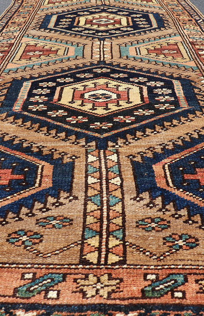 Antique Persian Kurdish Short Runner on Geometric Motifs in Light Camel Field. Medallion design on camel field, with dark blue medallions, green, red, blue , rug EMB - 8546 - 178695, country of origin / type: Iran / Hamedan, circa 1910 This ... - Keivan Woven ArtsEMB - 8546 - 178695 - 13812Rug