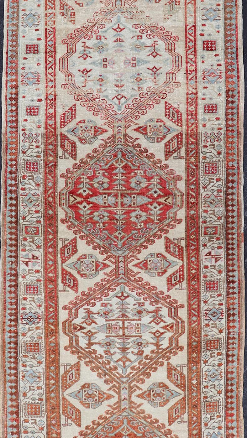 Antique Hand - Knotted Sarab Runner with Sub - Geometric Design in Red, Blue & Ivory This antique hand - knotted Sarab runner features a sub - geometric design accentuated by various motifs. The entirety of the piece is enclosed within a complementary,... - Keivan Woven ArtsEMB - 8548 - 178963 - 13818Rug