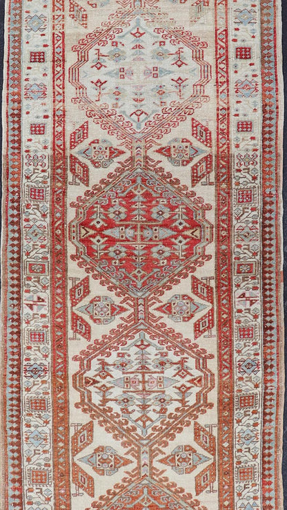 Antique Hand - Knotted Sarab Runner with Sub - Geometric Design in Red, Blue & Ivory This antique hand - knotted Sarab runner features a sub - geometric design accentuated by various motifs. The entirety of the piece is enclosed within a complementary,... - Keivan Woven ArtsEMB - 8548 - 178963 - 13818Rug