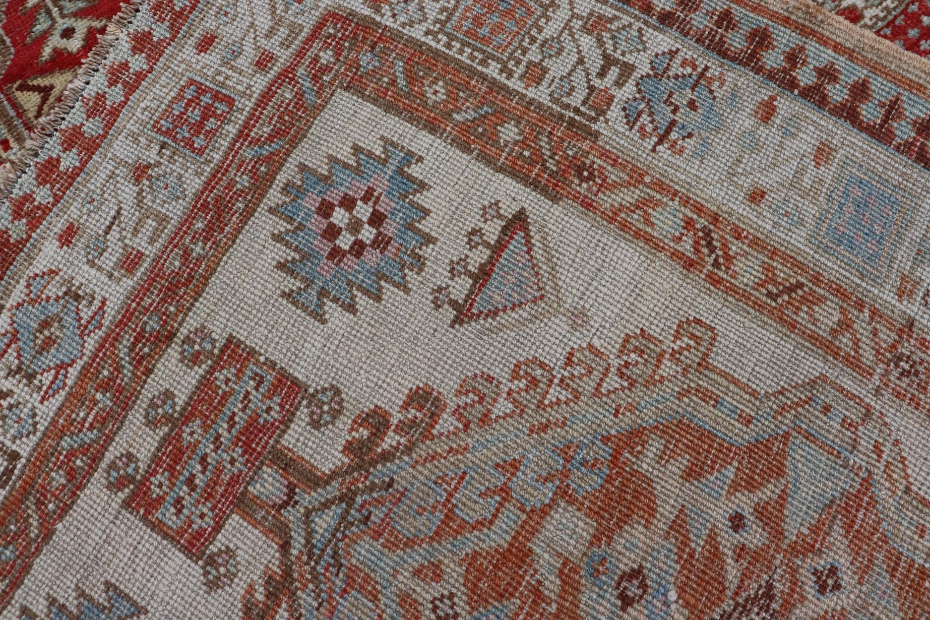 Antique Hand - Knotted Sarab Runner with Sub - Geometric Design in Red, Blue & Ivory This antique hand - knotted Sarab runner features a sub - geometric design accentuated by various motifs. The entirety of the piece is enclosed within a complementary,... - Keivan Woven ArtsEMB - 8548 - 178963 - 13818Rug