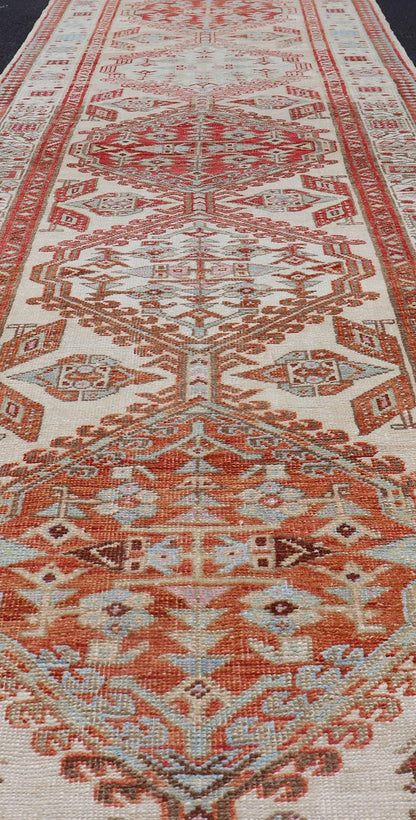 Antique Hand - Knotted Sarab Runner with Sub - Geometric Design in Red, Blue & Ivory This antique hand - knotted Sarab runner features a sub - geometric design accentuated by various motifs. The entirety of the piece is enclosed within a complementary,... - Keivan Woven ArtsEMB - 8548 - 178963 - 13818Rug