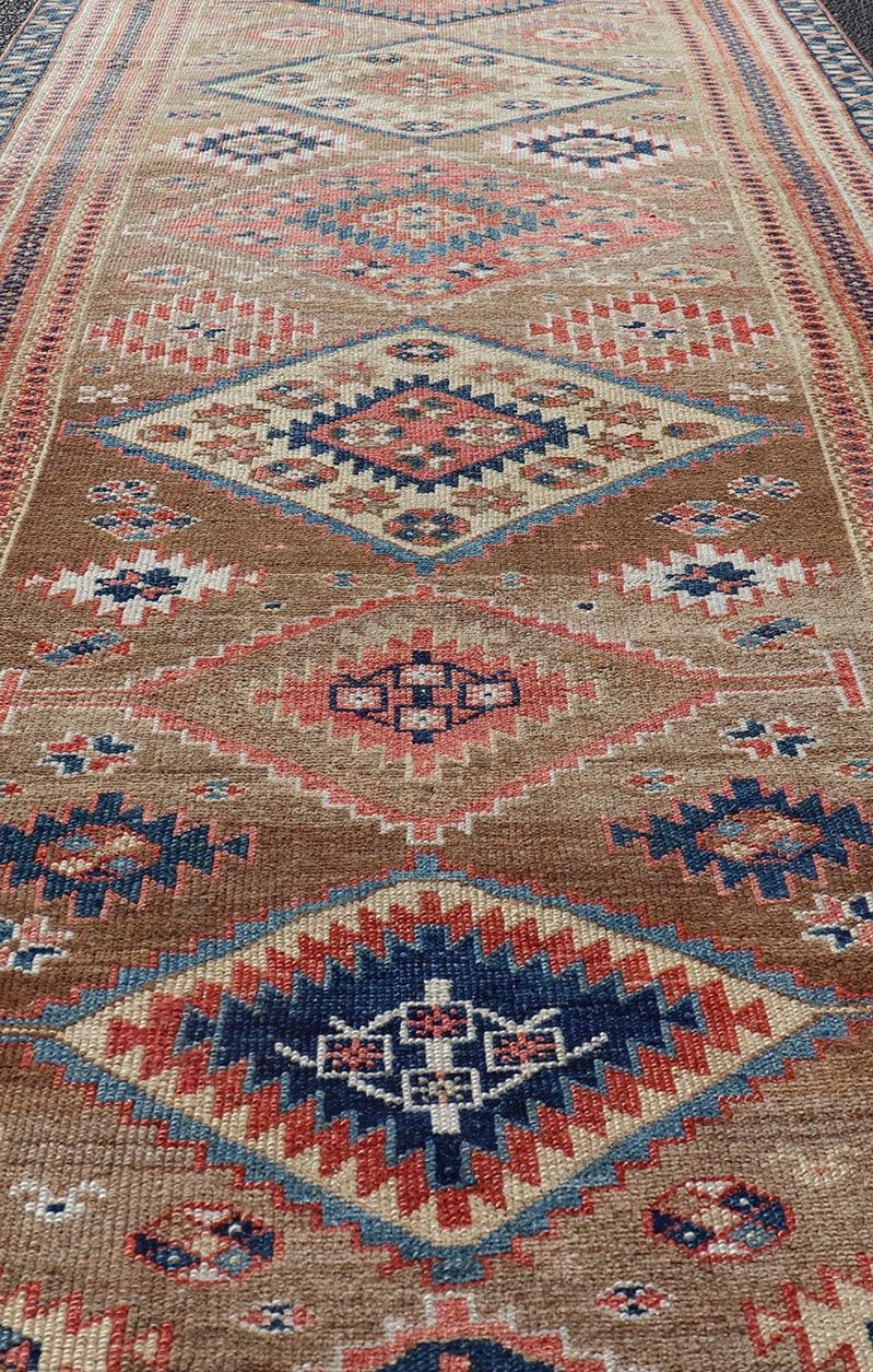 Antique Persian Kurdish Short Runner With Geometric Motifs in Light Camel Field Antique Persian Kurdish Short Runner With Geometric Motifs in Light Camel Field Medallion design on camel field, dark blue, red, ivory, and camel. Keivan Woven A... - Keivan Woven ArtsEMB - 9505 - P13067 - 14608Rug