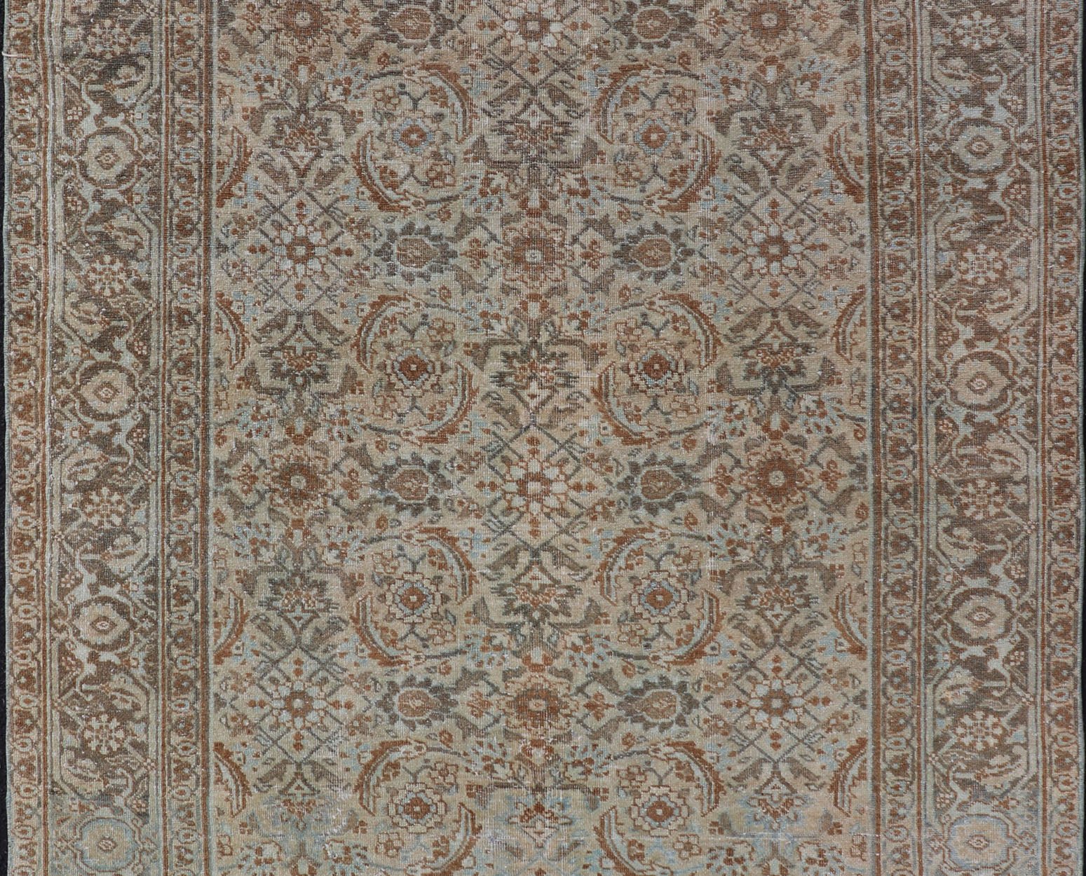 Antique Persian Tabriz Rug in Wool with All - Over Floral Design in Earth Colors This Tabriz rug features a relatively intricate and detailed border area and an entirely sparse and small repeating tribal motif in the center field. The tones of th... - Keivan Woven ArtsEMB - 9516 - P13065 - 14644Rug