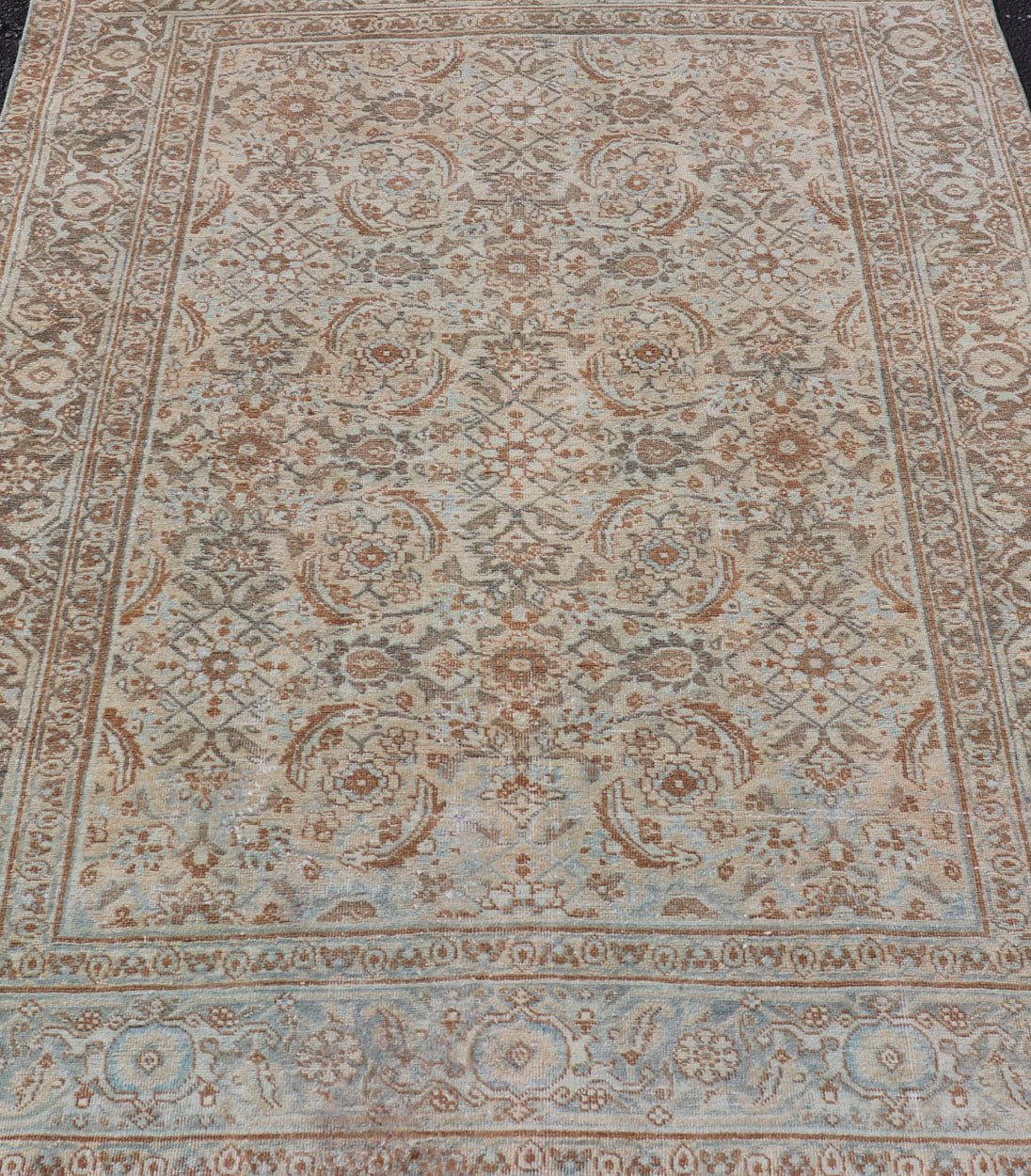 Antique Persian Tabriz Rug in Wool with All - Over Floral Design in Earth Colors This Tabriz rug features a relatively intricate and detailed border area and an entirely sparse and small repeating tribal motif in the center field. The tones of th... - Keivan Woven ArtsEMB - 9516 - P13065 - 14644Rug
