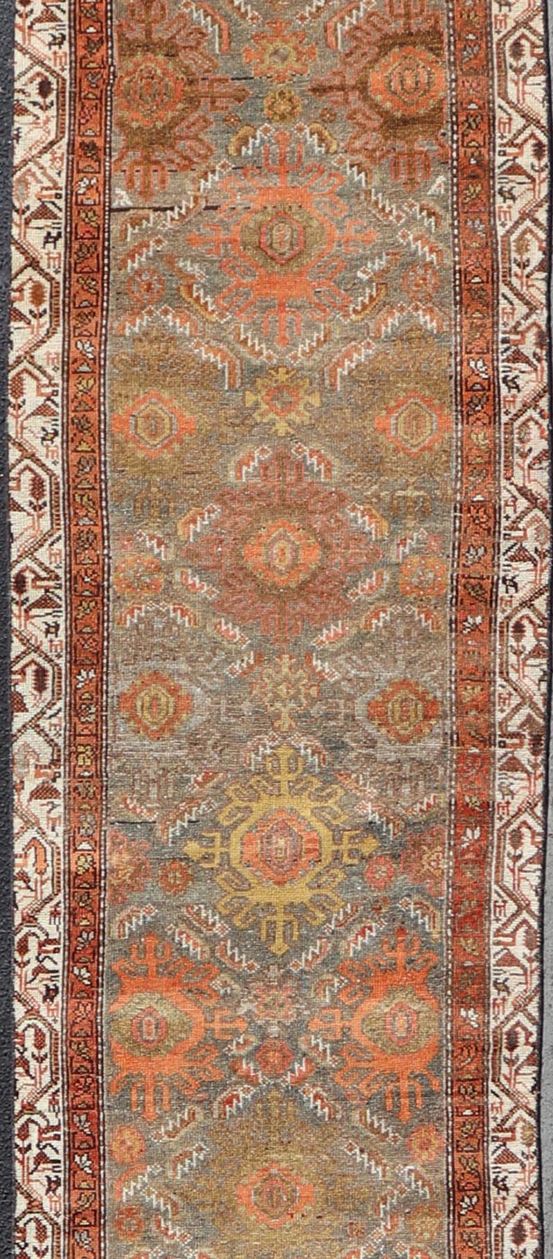 Antique Persian Hamadan Long Runner in Brown, Gray and Earth Tones Measures 2'6 x 16'3 This grand runner features a beautiful desert palette of orange, rustic gold, taupe, dulled cream, red, and camel, with a bright white border filled w... - Keivan Woven ArtsEMB - 9524 - P13062 - 14674Rug