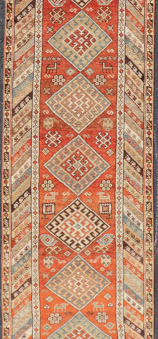 Antique Narrow And Long Kurdish Runner in Wool with Medallion Tribal Design This antique Persian Kurdish runner has been hand - knotted in wool and features a sub - geometric medallion design rendered in multicolor. A complementary, multi - tiered bor... - Keivan Woven ArtsEMB - 9525 - P13056 - 14680Rug