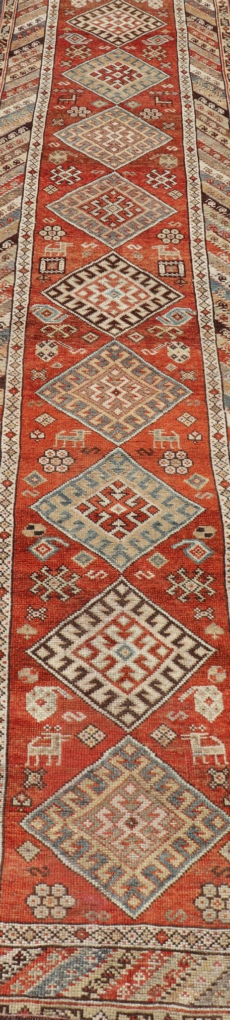 Antique Narrow And Long Kurdish Runner in Wool with Medallion Tribal Design This antique Persian Kurdish runner has been hand - knotted in wool and features a sub - geometric medallion design rendered in multicolor. A complementary, multi - tiered bor... - Keivan Woven ArtsEMB - 9525 - P13056 - 14680Rug