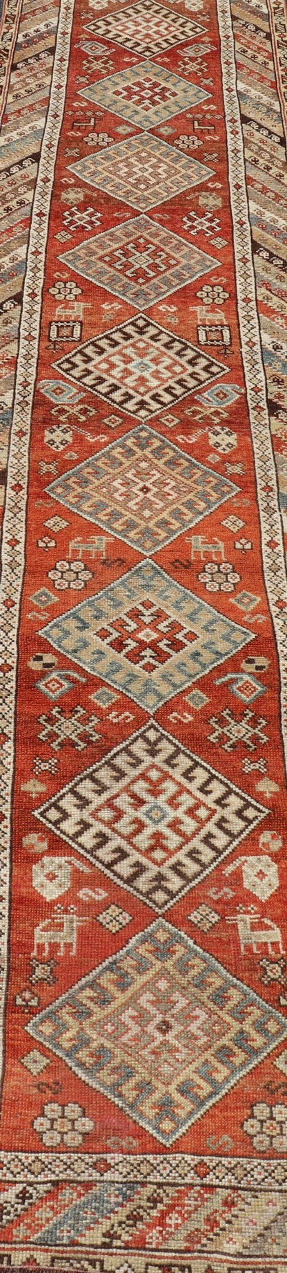 Antique Narrow And Long Kurdish Runner in Wool with Medallion Tribal Design This antique Persian Kurdish runner has been hand - knotted in wool and features a sub - geometric medallion design rendered in multicolor. A complementary, multi - tiered bor... - Keivan Woven ArtsEMB - 9525 - P13056 - 14680Rug