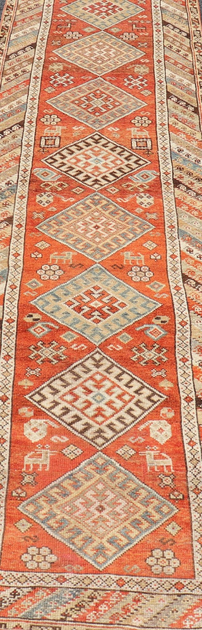 Antique Narrow And Long Kurdish Runner in Wool with Medallion Tribal Design This antique Persian Kurdish runner has been hand - knotted in wool and features a sub - geometric medallion design rendered in multicolor. A complementary, multi - tiered bor... - Keivan Woven ArtsEMB - 9525 - P13056 - 14680Rug