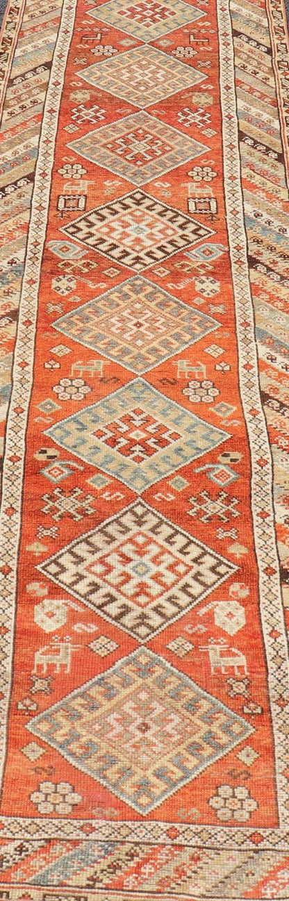 Antique Narrow And Long Kurdish Runner in Wool with Medallion Tribal Design This antique Persian Kurdish runner has been hand - knotted in wool and features a sub - geometric medallion design rendered in multicolor. A complementary, multi - tiered bor... - Keivan Woven ArtsEMB - 9525 - P13056 - 14680Rug