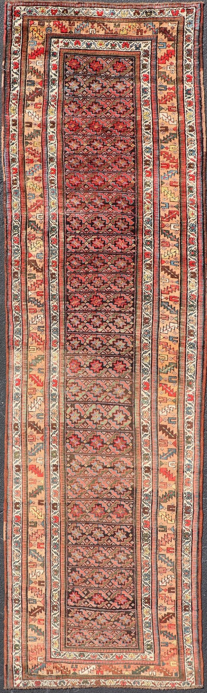 Antique Kurdish Runner with All - Over Geometric Design on A Blue Background Measures: 3'9 x 13'7 This antique runner from Persia features geometric tribal star motifs in a blue background, with accent colors of red, blue, green, and ... - Keivan Woven ArtsEMB - 9526 - P13054 - 14686Rug