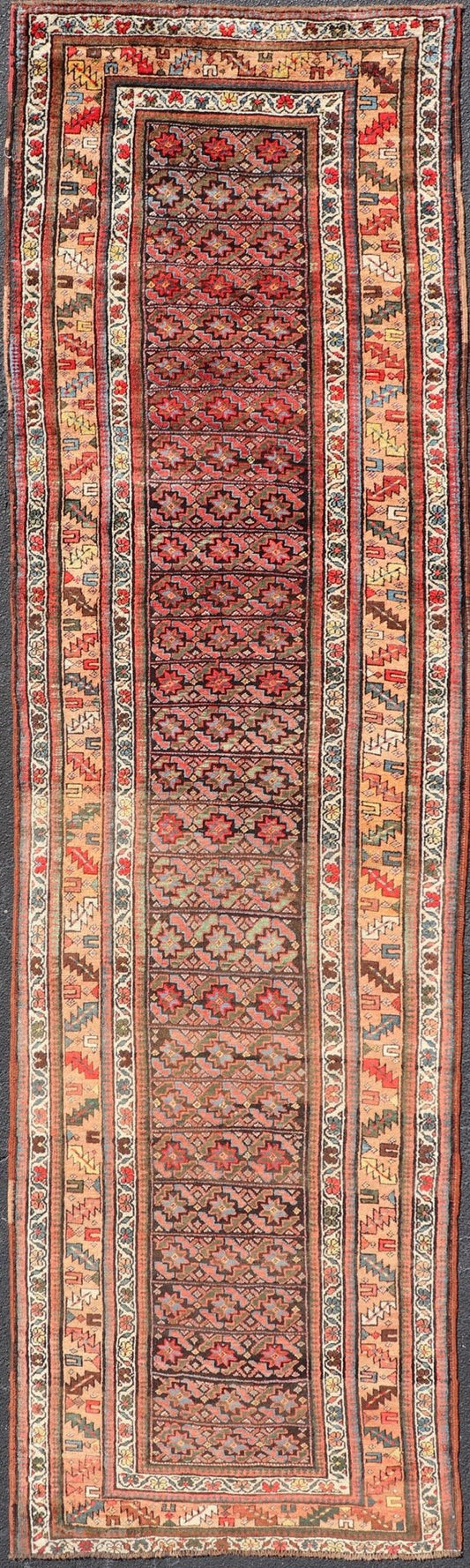 Antique Kurdish Runner with All - Over Geometric Design on A Blue Background Measures: 3'9 x 13'7 This antique runner from Persia features geometric tribal star motifs in a blue background, with accent colors of red, blue, green, and ... - Keivan Woven ArtsEMB - 9526 - P13054 - 14686Rug