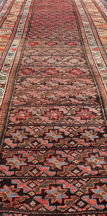 Antique Kurdish Runner with All - Over Geometric Design on A Blue Background Measures: 3'9 x 13'7 This antique runner from Persia features geometric tribal star motifs in a blue background, with accent colors of red, blue, green, and ... - Keivan Woven ArtsEMB - 9526 - P13054 - 14686Rug