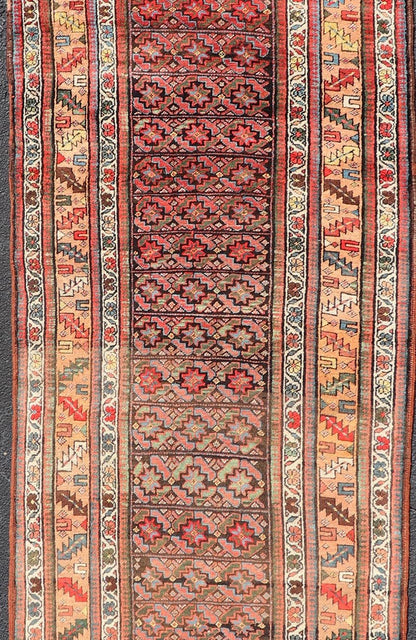 Antique Kurdish Runner with All - Over Geometric Design on A Blue Background Measures: 3'9 x 13'7 This antique runner from Persia features geometric tribal star motifs in a blue background, with accent colors of red, blue, green, and ... - Keivan Woven ArtsEMB - 9526 - P13054 - 14686Rug