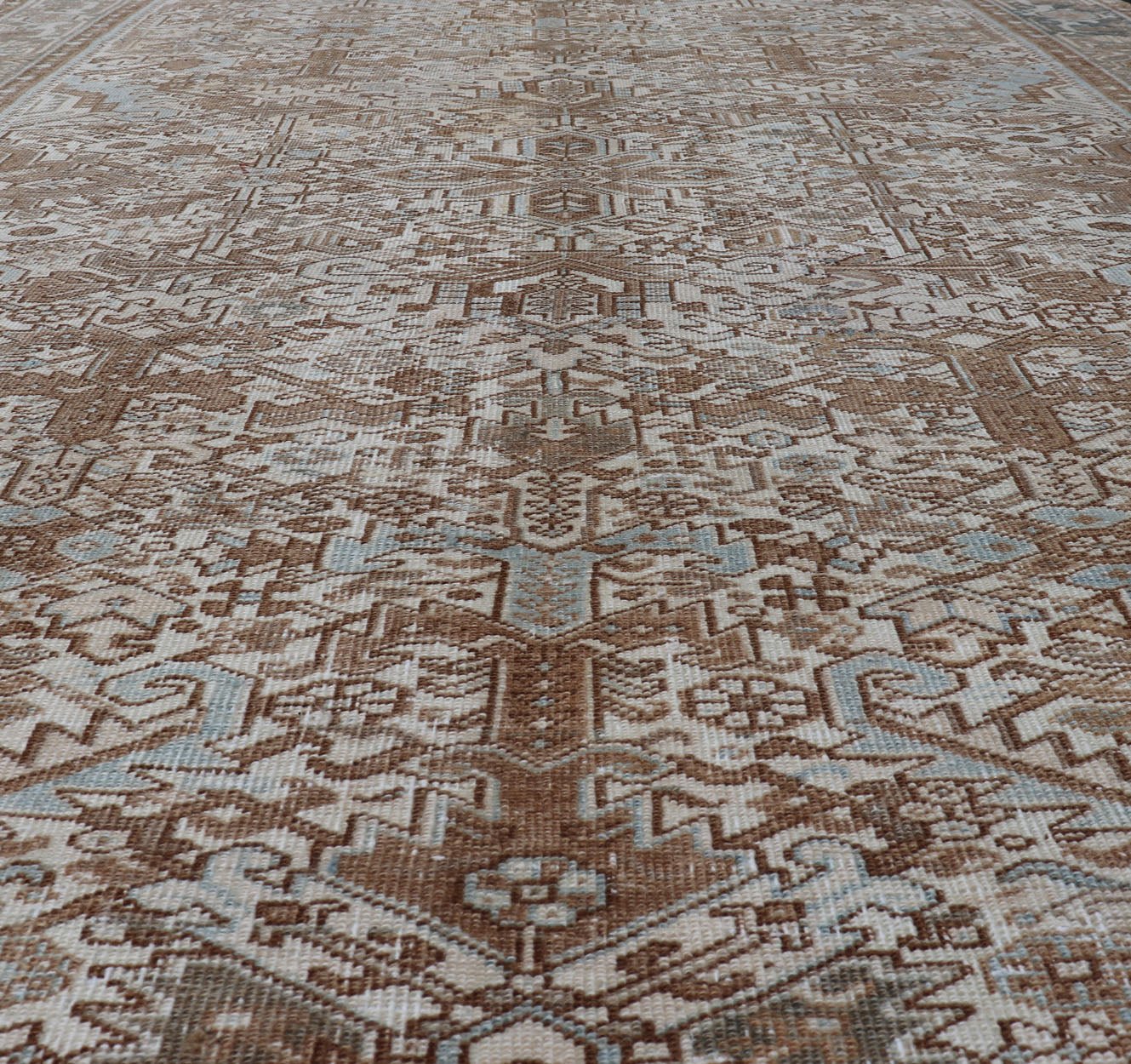 Vintage Hand - Knotted Heriz Rug with Sub - Geometric Design in Natural Tones This vintage hand - knotted Persian Heriz rug features an all - over sub - geometric design, enclosed within a complementary, multi - tiered border. The rug is rendered in blues... - Keivan Woven ArtsEMB - 9540 - P13089 - 14758Rug