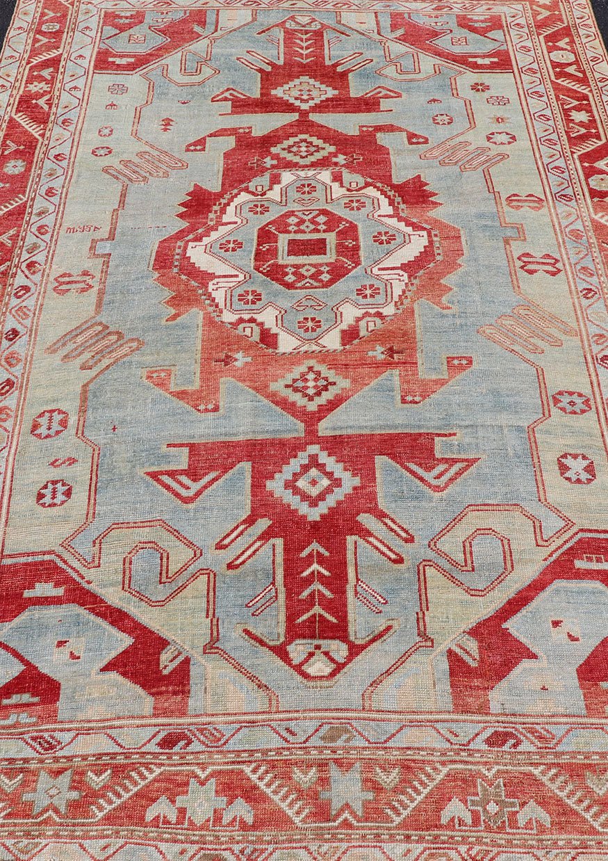 Antique Caucasian Kazak Rug with Tribal Geometric Medallion In Red. light green, ivory & Lt. Blue. Tribal geometric with stretched medallion design antique Kazak rug, antique rug from Caucasus Region in multi - colors. Keivan Woven Arts / rug EMB - ... - Keivan Woven ArtsEMB - 9552 - P13035 - 14818Rug