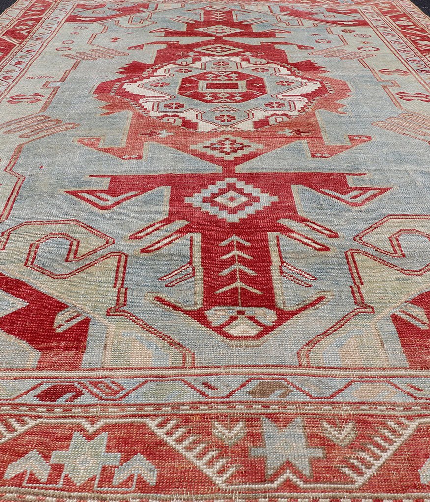 Antique Caucasian Kazak Rug with Tribal Geometric Medallion In Red. light green, ivory & Lt. Blue. Tribal geometric with stretched medallion design antique Kazak rug, antique rug from Caucasus Region in multi - colors. Keivan Woven Arts / rug EMB - ... - Keivan Woven ArtsEMB - 9552 - P13035 - 14818Rug