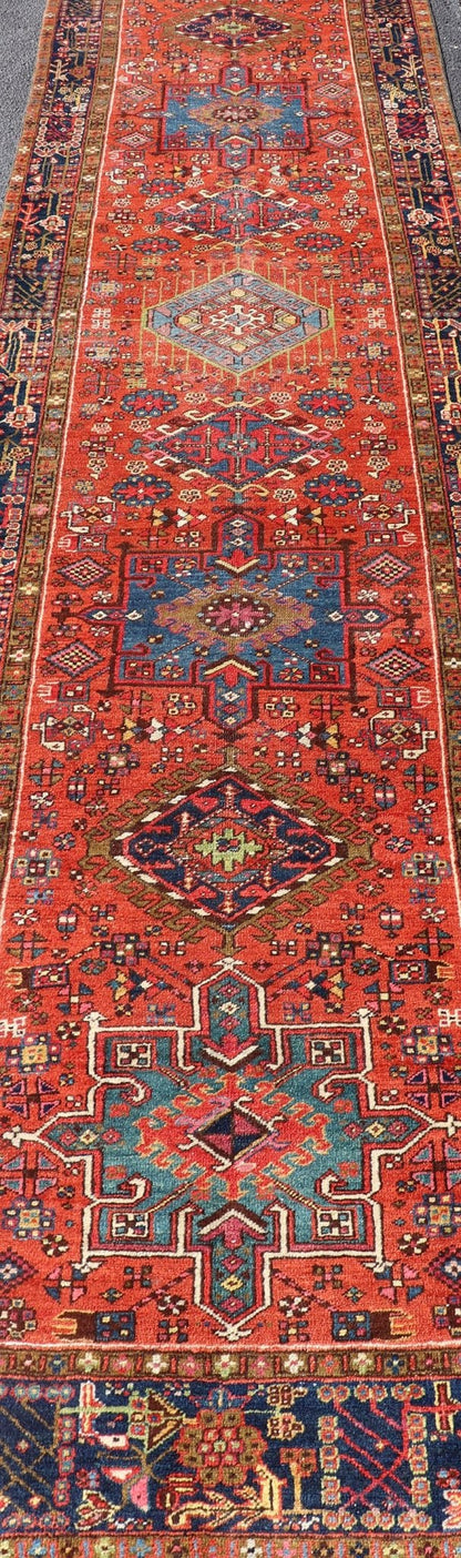 Very Long antique Persian Heriz runner with geometric medallion design in red, blue and colorful tones. Keivan Woven Arts / rug EMB - 9560 - P13076 , country of origin / type: Iran / Heriz, circa 1900 Measures:3'4 x 14'4 Antique Hand Knotted ... - Keivan Woven ArtsEMB - 9560 - P13076 - 14568Rug