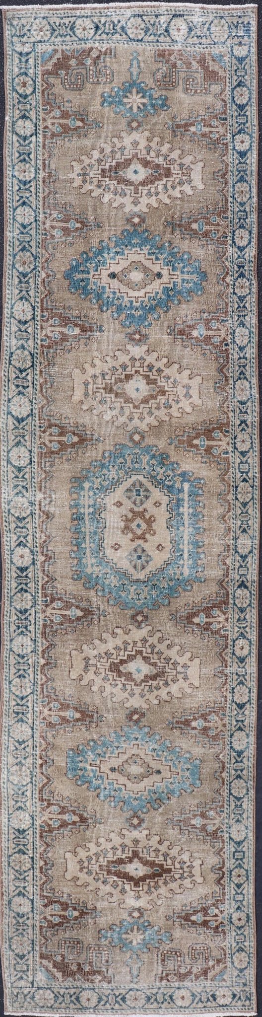 Long Hand - Knotted Antique Heriz Runner in Wool with Sub - Geometric Medallions This antique Persian Heriz runner features a sub - geometric medallion design rendered in blue, tan, brown and cream tones, set upon a tan background. A complementary, m... - Keivan Woven ArtsEMB - 9563 - P13884 - 14910Rug