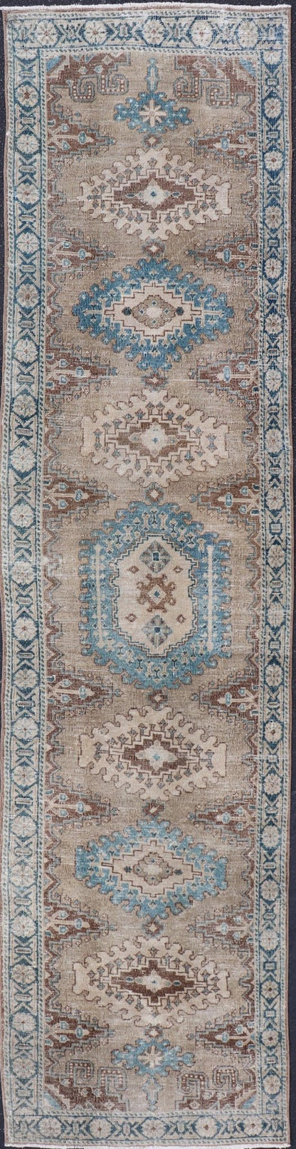 Long Hand - Knotted Antique Heriz Runner in Wool with Sub - Geometric Medallions This antique Persian Heriz runner features a sub - geometric medallion design rendered in blue, tan, brown and cream tones, set upon a tan background. A complementary, m... - Keivan Woven ArtsEMB - 9563 - P13884 - 14910Rug