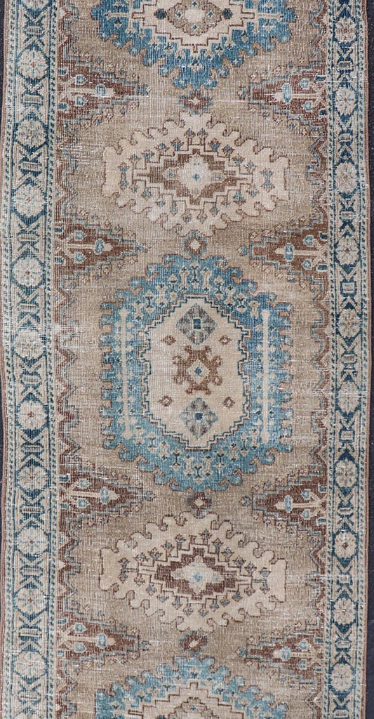 Long Hand - Knotted Antique Heriz Runner in Wool with Sub - Geometric Medallions This antique Persian Heriz runner features a sub - geometric medallion design rendered in blue, tan, brown and cream tones, set upon a tan background. A complementary, m... - Keivan Woven ArtsEMB - 9563 - P13884 - 14910Rug