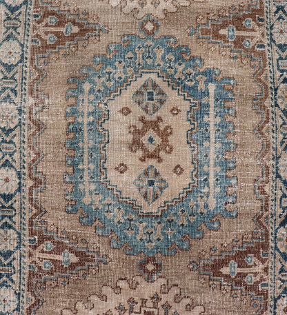 Long Hand - Knotted Antique Heriz Runner in Wool with Sub - Geometric Medallions This antique Persian Heriz runner features a sub - geometric medallion design rendered in blue, tan, brown and cream tones, set upon a tan background. A complementary, m... - Keivan Woven ArtsEMB - 9563 - P13884 - 14910Rug