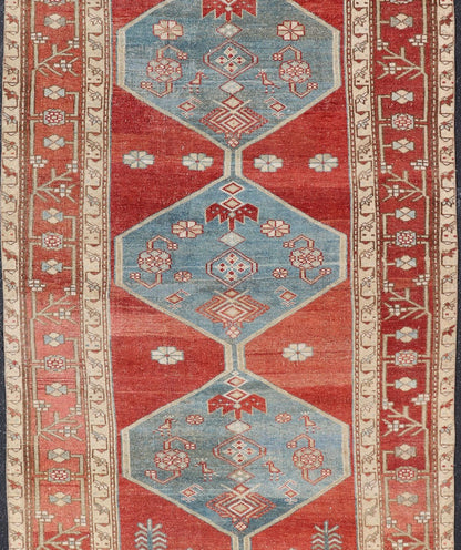 Antique Kurdish Medallion Gallery Runner in Red, Denim Blue, and Eggshell With brilliant design and vibrant colors, this Kurdish medallion - designed gallery runner features a bold burnt red, accompanied by a soft denim blue. Accent motifs of fawn... - Keivan Woven ArtsEMB - 9564 - P13082 - 14916Rug