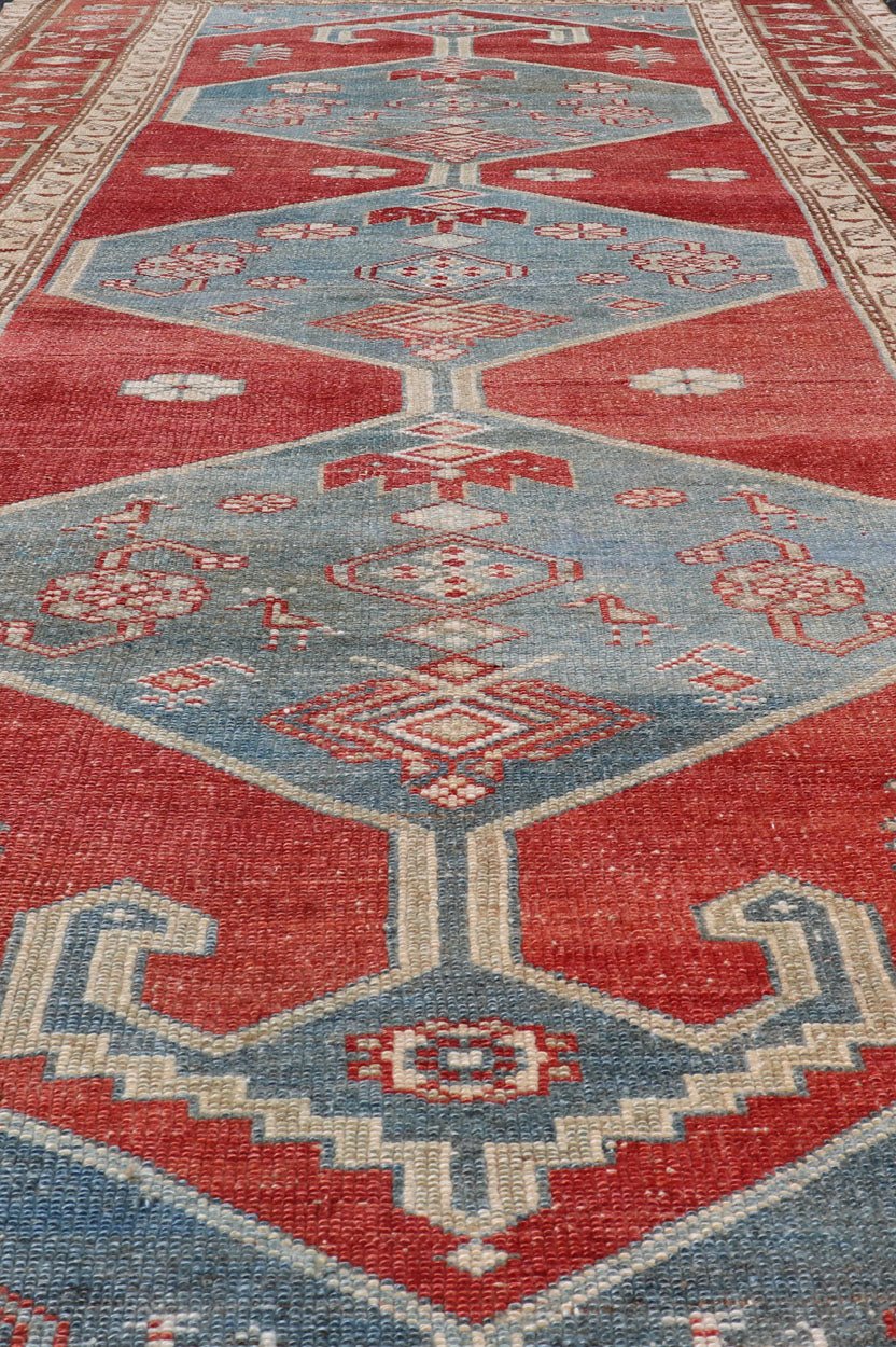 Antique Kurdish Medallion Gallery Runner in Red, Denim Blue, and Eggshell With brilliant design and vibrant colors, this Kurdish medallion - designed gallery runner features a bold burnt red, accompanied by a soft denim blue. Accent motifs of fawn... - Keivan Woven ArtsEMB - 9564 - P13082 - 14916Rug