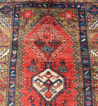 Antique Persian Heriz Runner in Reds, Blues, Pink, Ivory and Earthy Tones This gorgeous antique Persian Heriz runner features a red background imbued with ornate medallions running along the piece. Sub - geometric designs decorate the field, and a... - Keivan Woven ArtsEMB - 9577 - P13510 - 15128Rug
