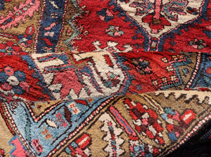 Antique Persian Heriz Runner in Reds, Blues, Pink, Ivory and Earthy Tones This gorgeous antique Persian Heriz runner features a red background imbued with ornate medallions running along the piece. Sub - geometric designs decorate the field, and a... - Keivan Woven ArtsEMB - 9577 - P13510 - 15128Rug