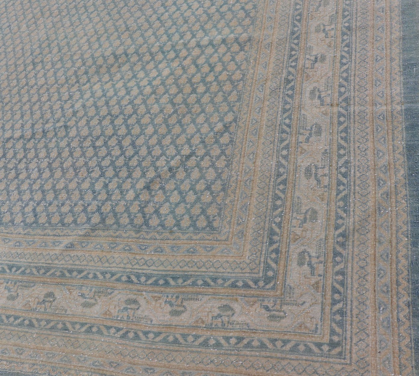 Hand - Knotted Antique Persian Tabriz Rug in Wool with Minimalist Design This Tabriz rug features a relatively intricate and detailed border area and an entirely sparse and small repeating tribal motif in the center field. The tones of this charm... - Keivan Woven ArtsEMB - 9583 - P13517 - 15164Rug