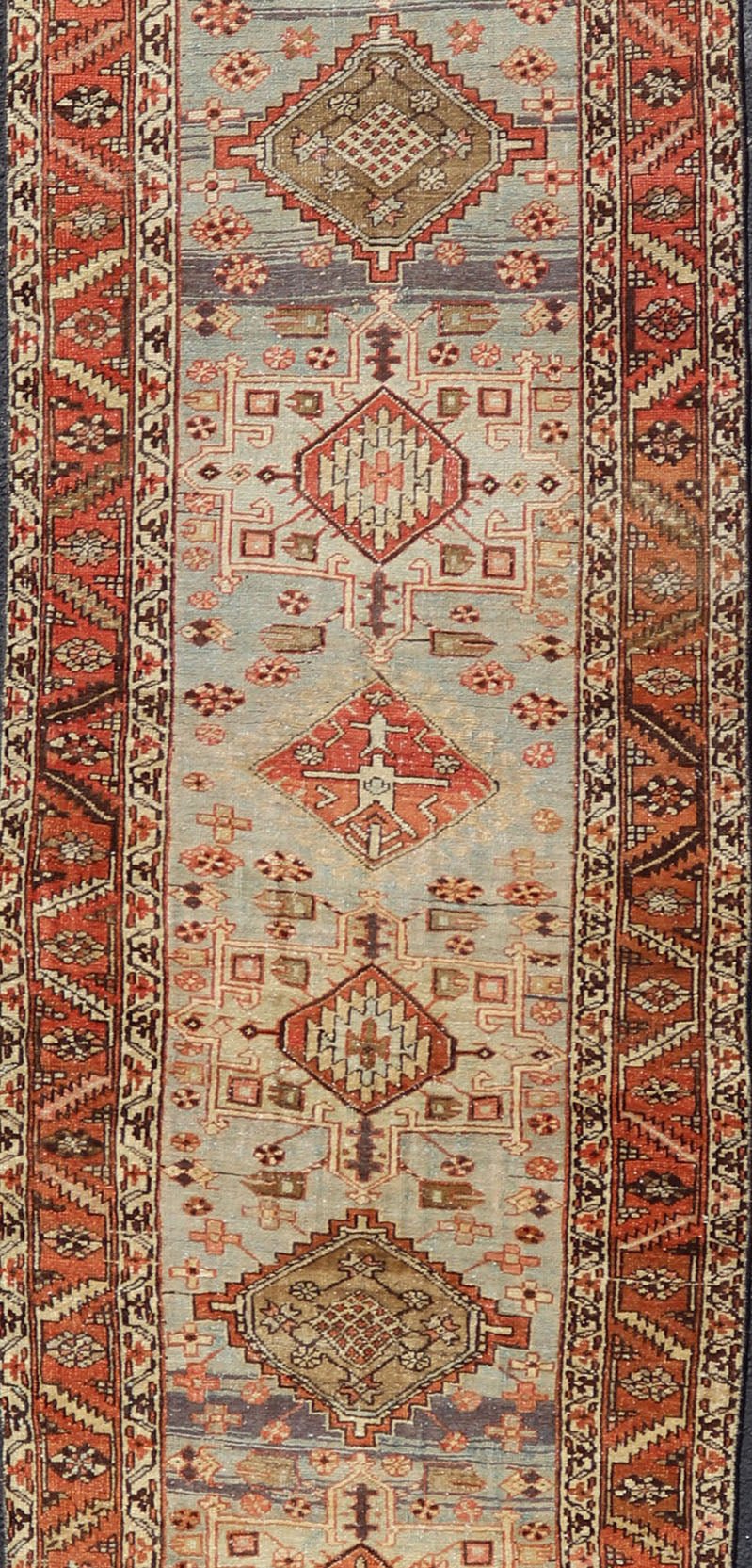 Multi Colored Long Antique Persian Heriz Runner with Geometric Medallions. Keivan Woven Arts / rug EMB - 9588 - P13575, country of origin / type: Iran / Heriz, circa 1910 This magnificent Heriz Serapi runner woven in the early 20th century bears an ... - Keivan Woven ArtsEMB - 9588 - P13575 - 15190Rug