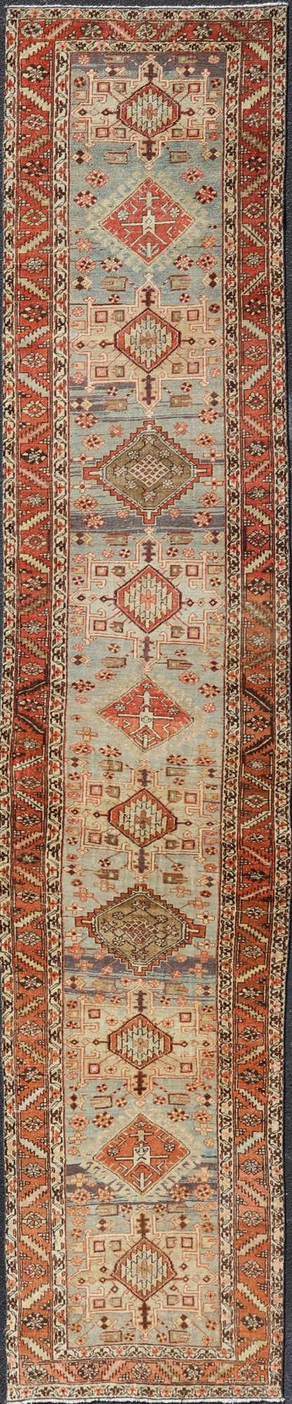 Multi Colored Long Antique Persian Heriz Runner with Geometric Medallions. Keivan Woven Arts / rug EMB - 9588 - P13575, country of origin / type: Iran / Heriz, circa 1910 This magnificent Heriz Serapi runner woven in the early 20th century bears an ... - Keivan Woven ArtsEMB - 9588 - P13575 - 15190Rug
