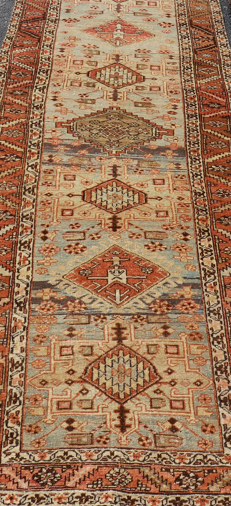 Multi Colored Long Antique Persian Heriz Runner with Geometric Medallions. Keivan Woven Arts / rug EMB - 9588 - P13575, country of origin / type: Iran / Heriz, circa 1910 This magnificent Heriz Serapi runner woven in the early 20th century bears an ... - Keivan Woven ArtsEMB - 9588 - P13575 - 15190Rug