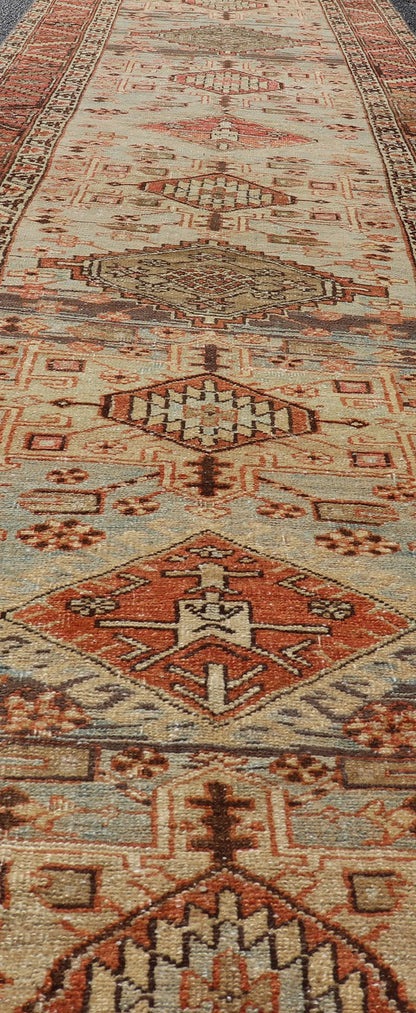 Multi Colored Long Antique Persian Heriz Runner with Geometric Medallions. Keivan Woven Arts / rug EMB - 9588 - P13575, country of origin / type: Iran / Heriz, circa 1910 This magnificent Heriz Serapi runner woven in the early 20th century bears an ... - Keivan Woven ArtsEMB - 9588 - P13575 - 15190Rug