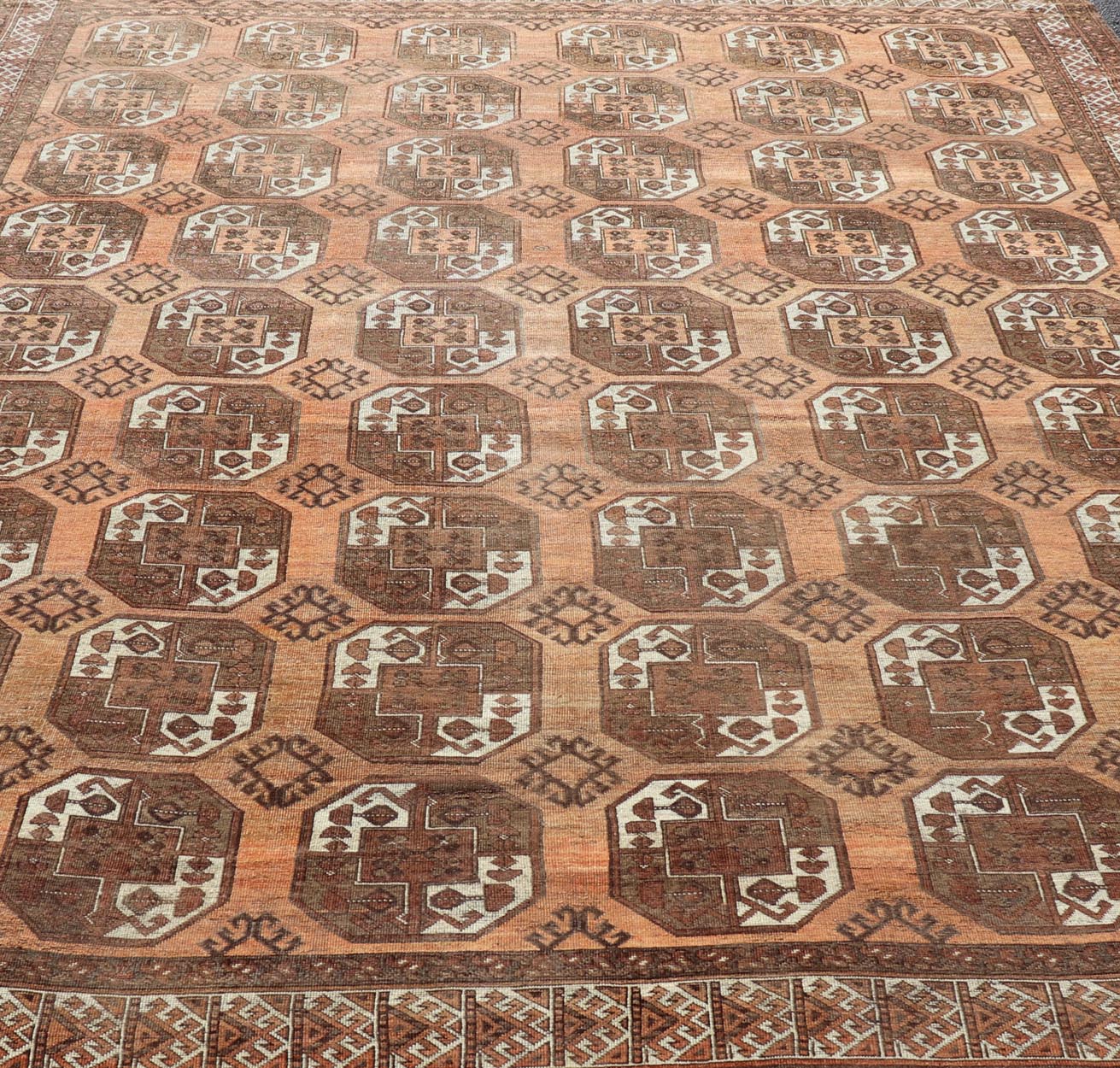 Measures:9'7 x 12'10 Antique Turkomen Ersari Rug in Wool with Repeating Gul Design in Orange, Brown. Keivan Woven Arts; rug EMB - 9594 - 13519, country of origin / type: Turkestan / Ersari, circa 1930s. This Ersari rug has been hand - knotted in th... - Keivan Woven ArtsEMB - 9594 - 13519 - 15613Rug