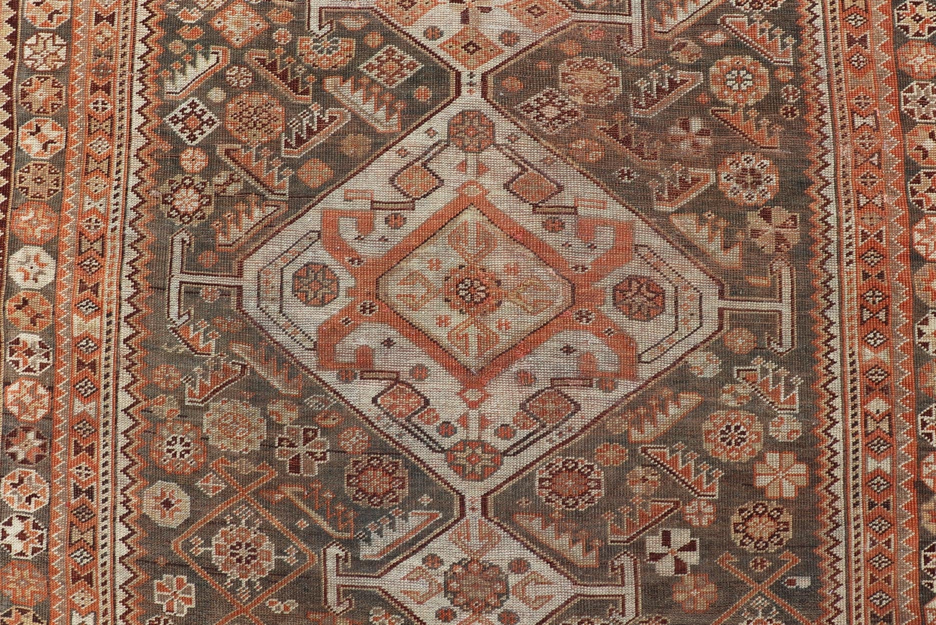 Antique Hand - Knotted Persian Shiraz in Wool with All - Over Medallion Design This antique Persian Shiraz rug has been hand - knotted in wool and features an all - over sub - geometric design rendered in multicolor. A complementary, multi - tiered border ... - Keivan Woven ArtsEMB - 9606 - P13865 - 15649Rug