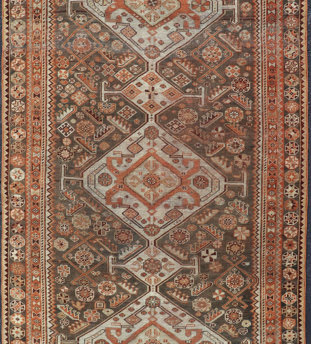 Antique Hand - Knotted Persian Shiraz in Wool with All - Over Medallion Design This antique Persian Shiraz rug has been hand - knotted in wool and features an all - over sub - geometric design rendered in multicolor. A complementary, multi - tiered border ... - Keivan Woven ArtsEMB - 9606 - P13865 - 15649Rug