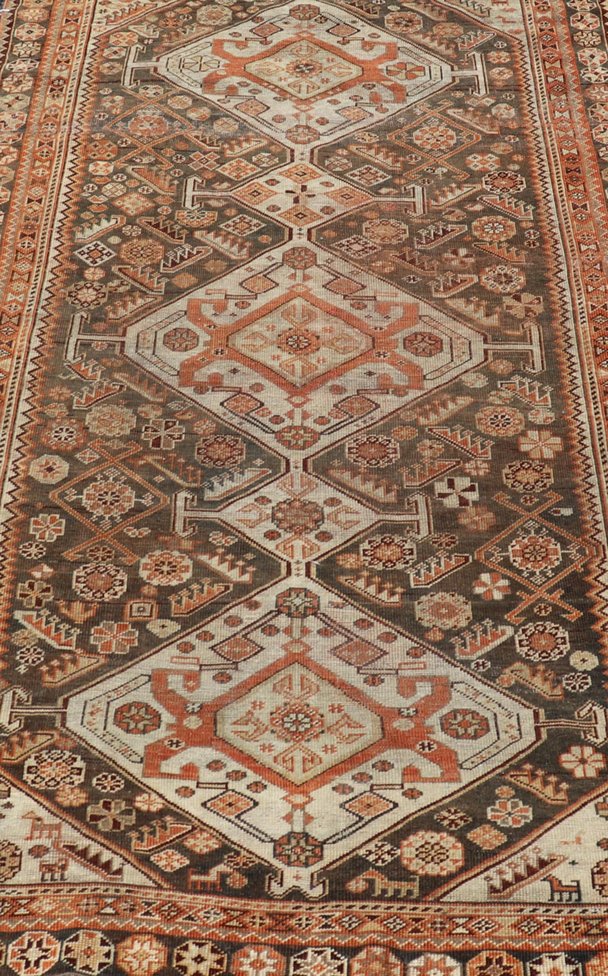 Antique Hand - Knotted Persian Shiraz in Wool with All - Over Medallion Design This antique Persian Shiraz rug has been hand - knotted in wool and features an all - over sub - geometric design rendered in multicolor. A complementary, multi - tiered border ... - Keivan Woven ArtsEMB - 9606 - P13865 - 15649Rug