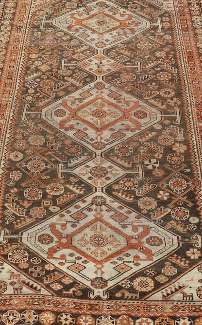 Antique Hand - Knotted Persian Shiraz in Wool with All - Over Medallion Design This antique Persian Shiraz rug has been hand - knotted in wool and features an all - over sub - geometric design rendered in multicolor. A complementary, multi - tiered border ... - Keivan Woven ArtsEMB - 9606 - P13865 - 15649Rug